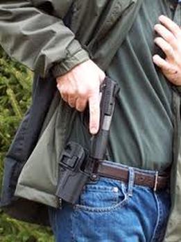 Man pulling gun out of its holster